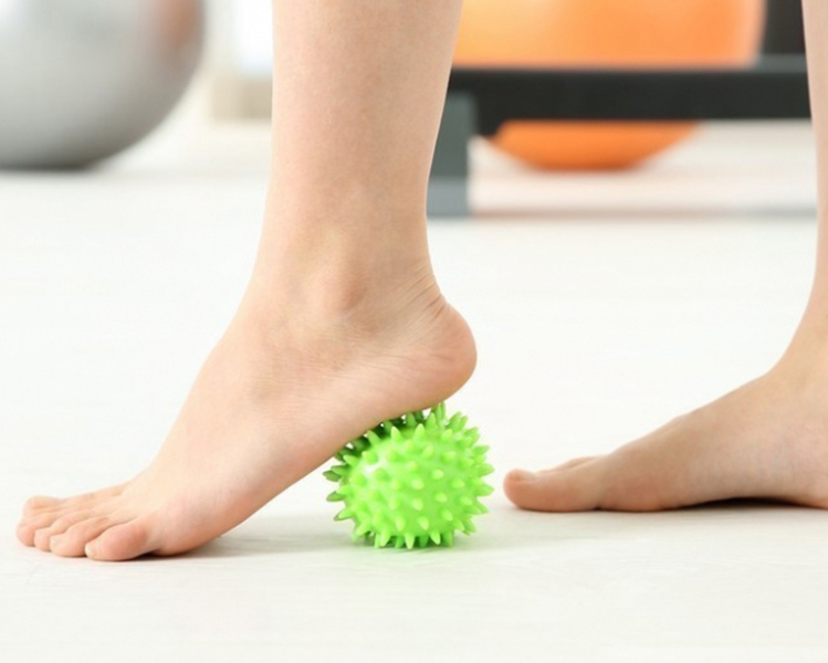 barefoot playing with a ball to do muscle exercises